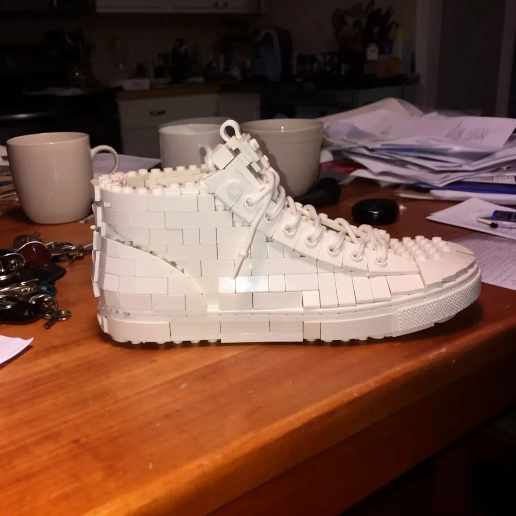 Image to image AI result: white sneaker turned into a LEGO brick model on the same kitchen table